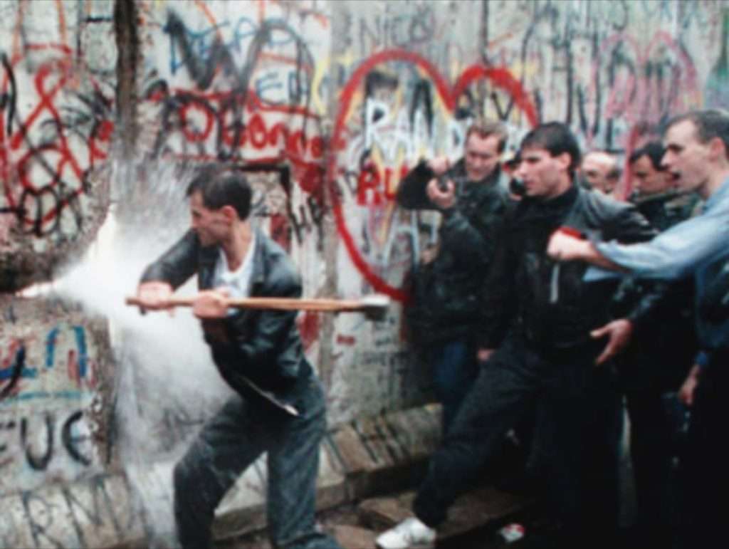 3 Persone che abbattono il Muro di Berlino la notte del 9 novembre 1989