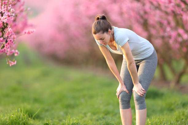 Exhausted runner resting after run in a pink field stanchezza di primavera